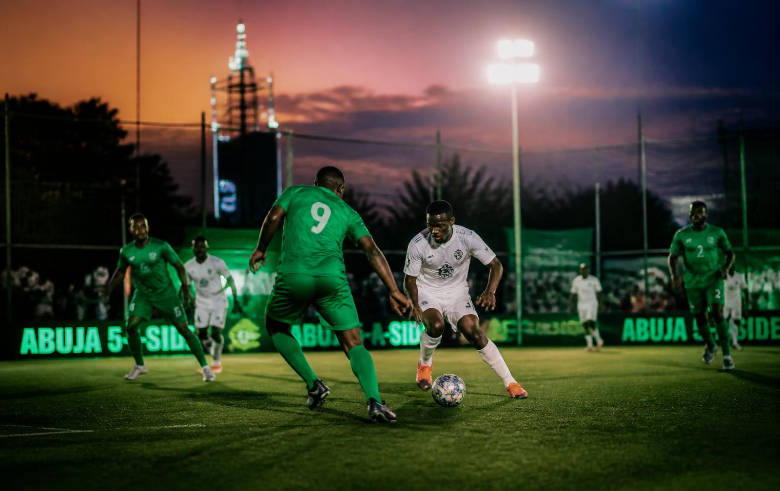 Five-a-side football match under floodlights in Abuja